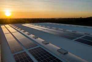 Green energy solar panels on roof of business warehouse