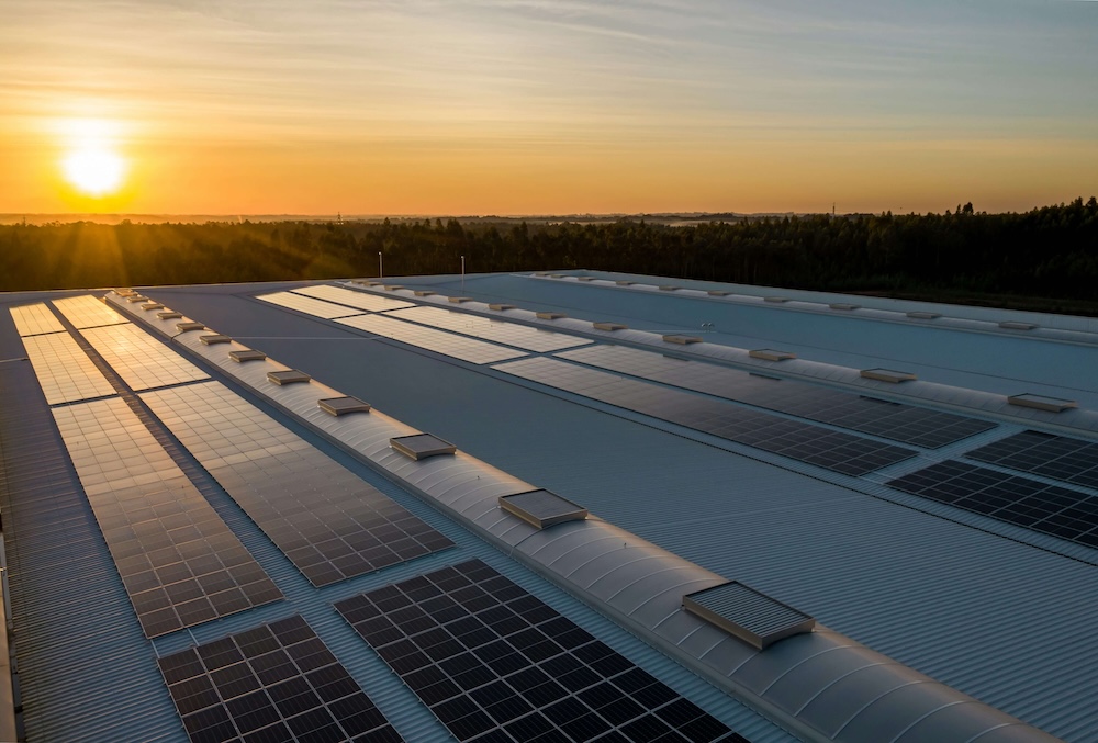 Green energy solar panels on roof of business warehouse